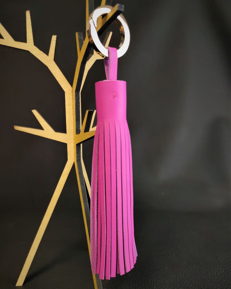 Pompon-porte-cles-cuir-fuchsia-accessoire-sacamain-maroquinerie-lyon-ofilducuir Pompon en cuir fuchsia un accessoire de sac à main bijou de sac